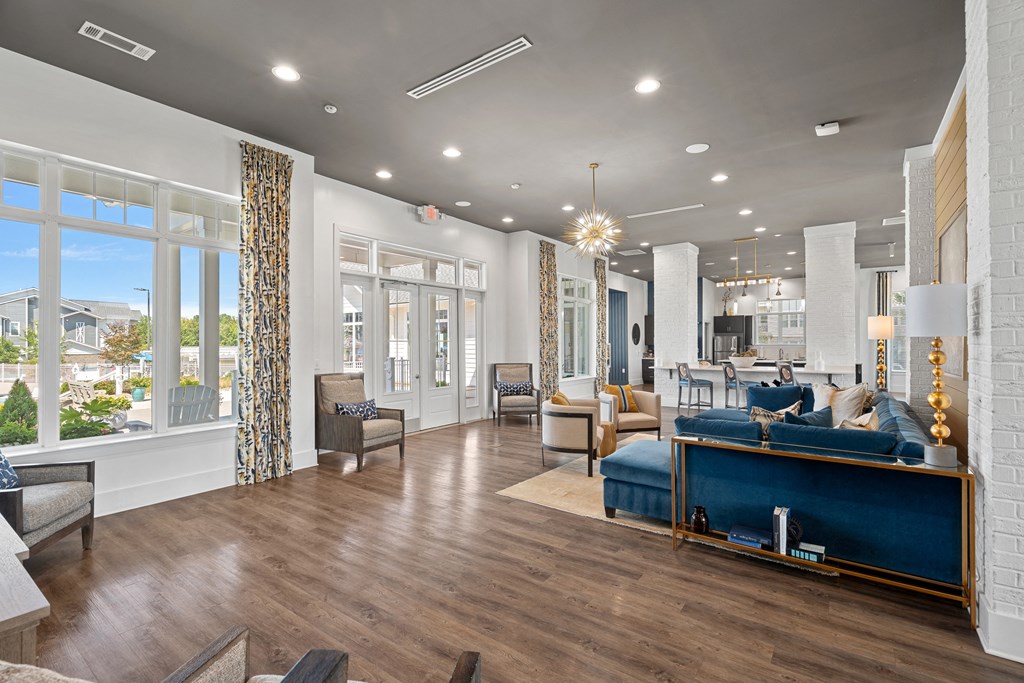 a living room with a blue couch and a large window