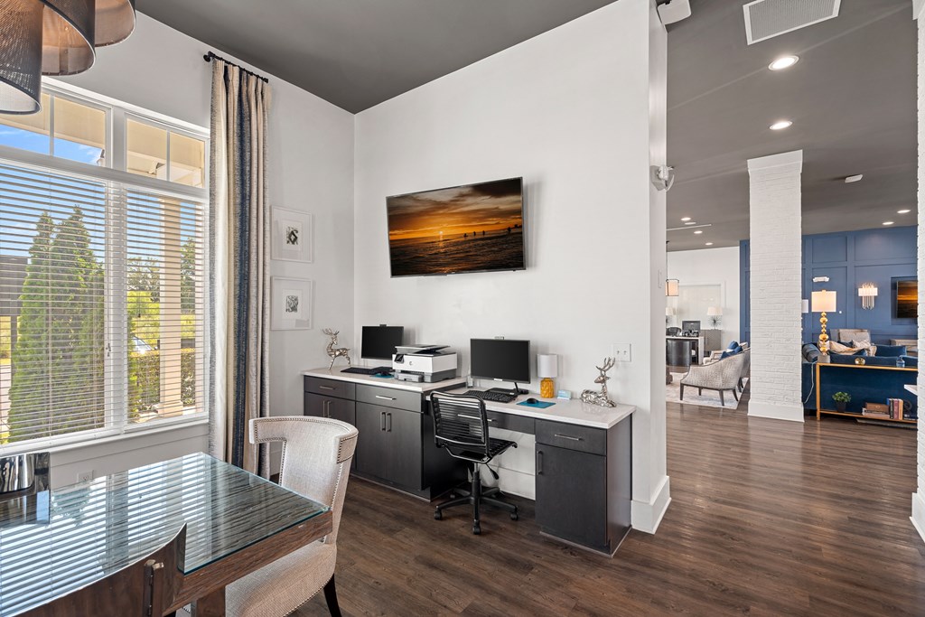 a kitchen and dining room with a desk and a tv