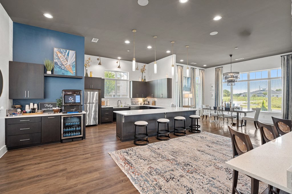 a kitchen with a large island and a dining room with a table and chairs