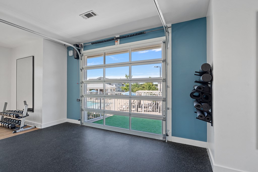 a garage door with a view of a yard and a house through it