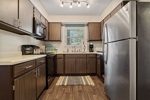 a kitchen with stainless steel appliances and wooden cabinets