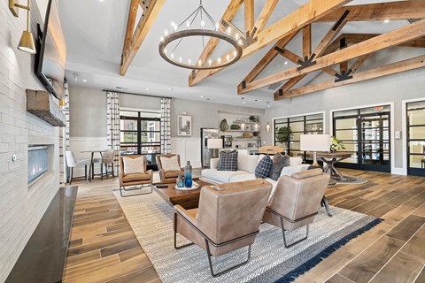 a living room with a couch and chairs and a fireplace