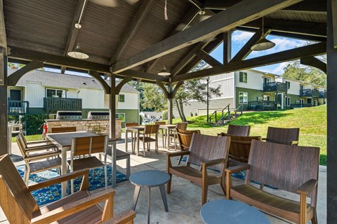a patio with tables and chairs and a gazebo