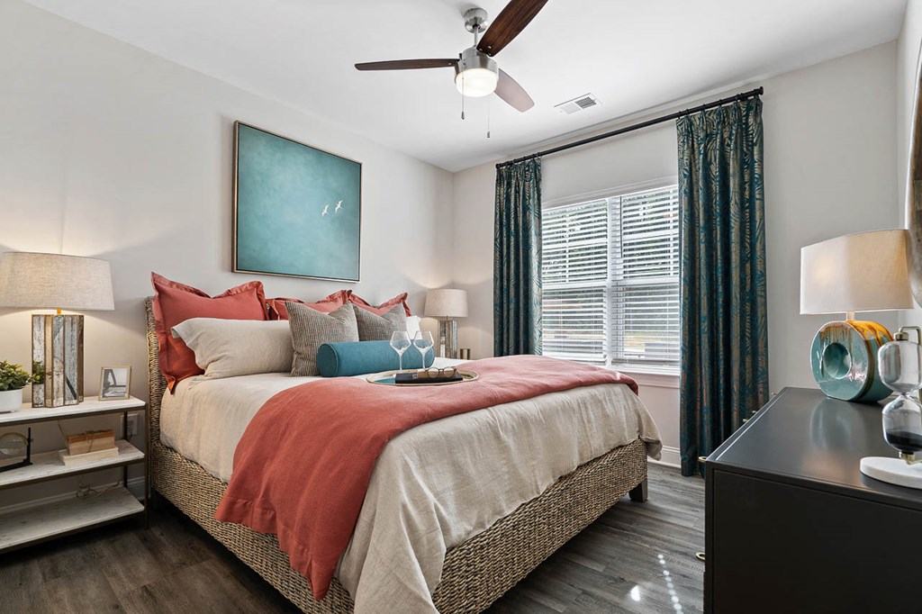 Spacious Bedroom with Large Windows and Ceiling Fan