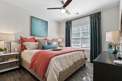 Spacious Bedroom with Large Windows and Ceiling Fan