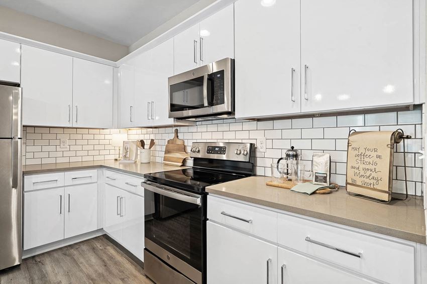 Home Interior a white kitchen with a stove and a microwave