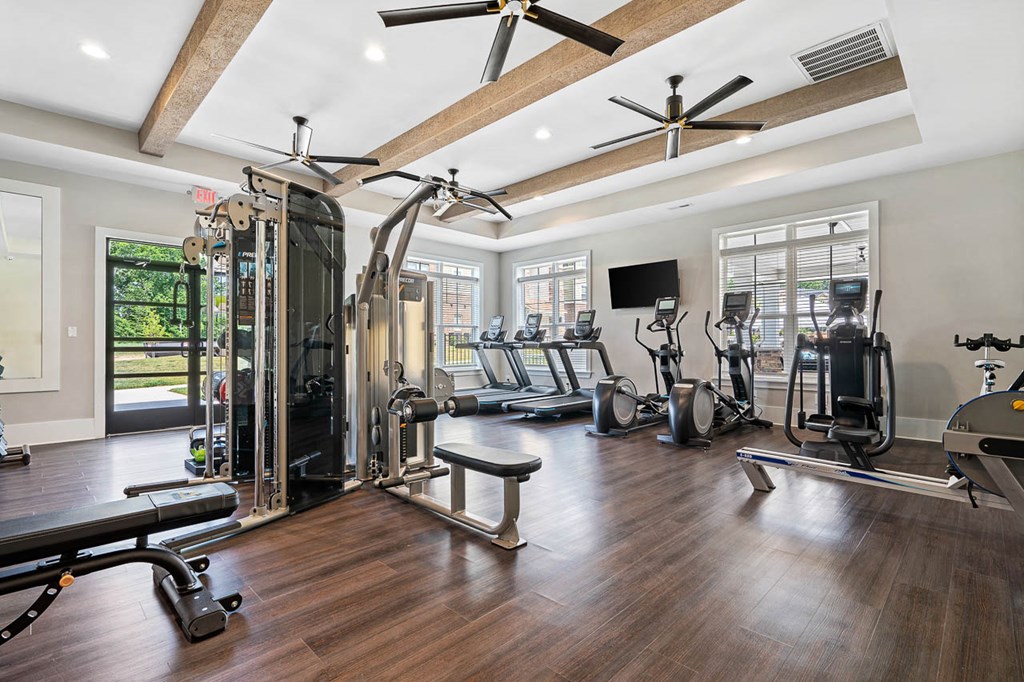 a home gym with exercise equipment and a window