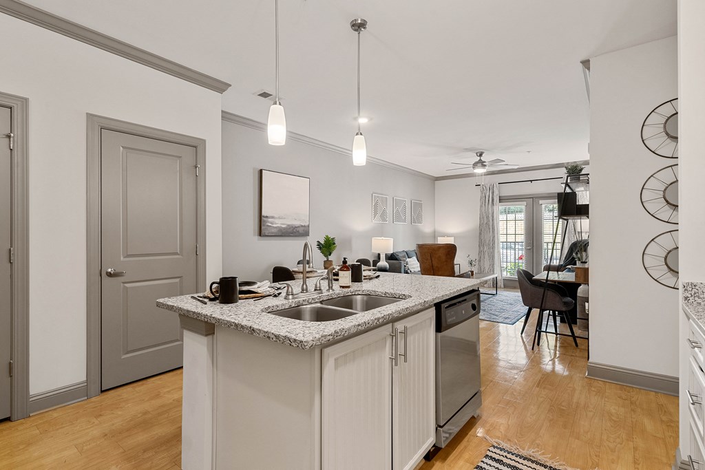 the kitchen and living room of a house with a counter top and a sink