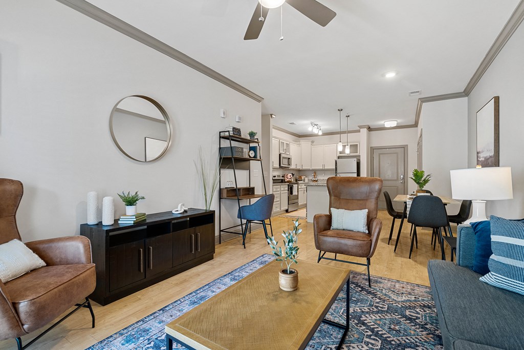 a living room with couches and chairs and a dining room table