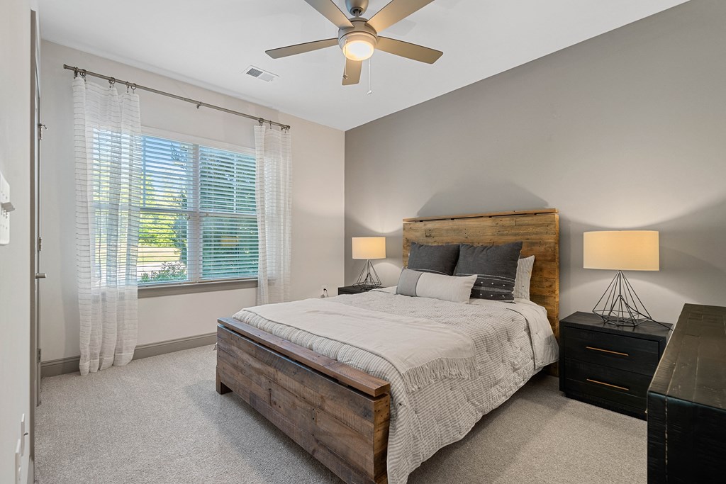 a bedroom with a bed and a ceiling fan