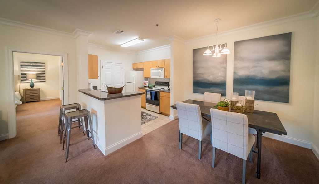 a kitchen and dining room with a table and chairs