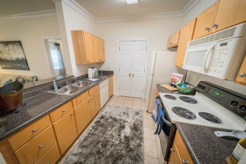 a kitchen with cabinets and a stove and a sink