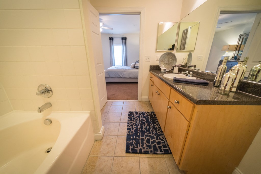 a reflection of a bathroom in a mirror on the wall