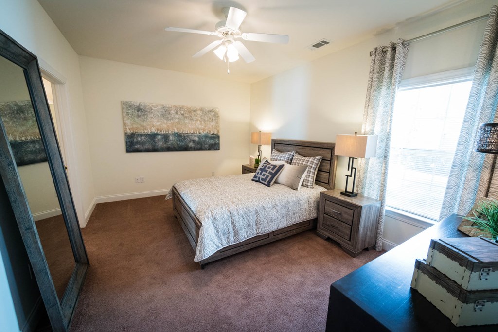 a bedroom with a bed and a ceiling fan