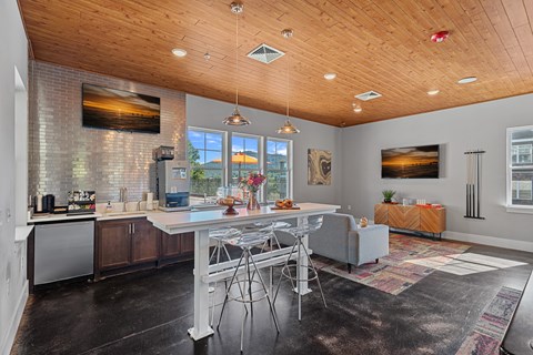 A modern kitchen with a dining table and chairs.