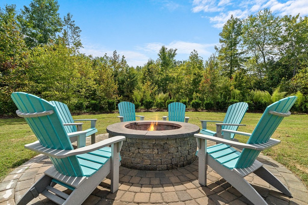 a group of lawn chairs around a fire pit