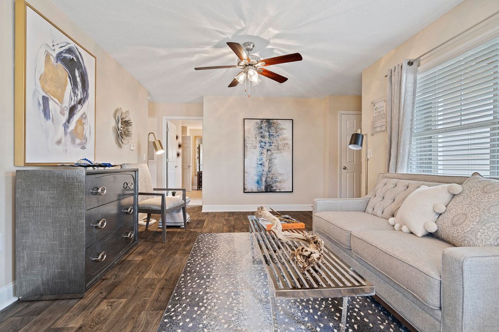 a living room with a couch and a ceiling fan