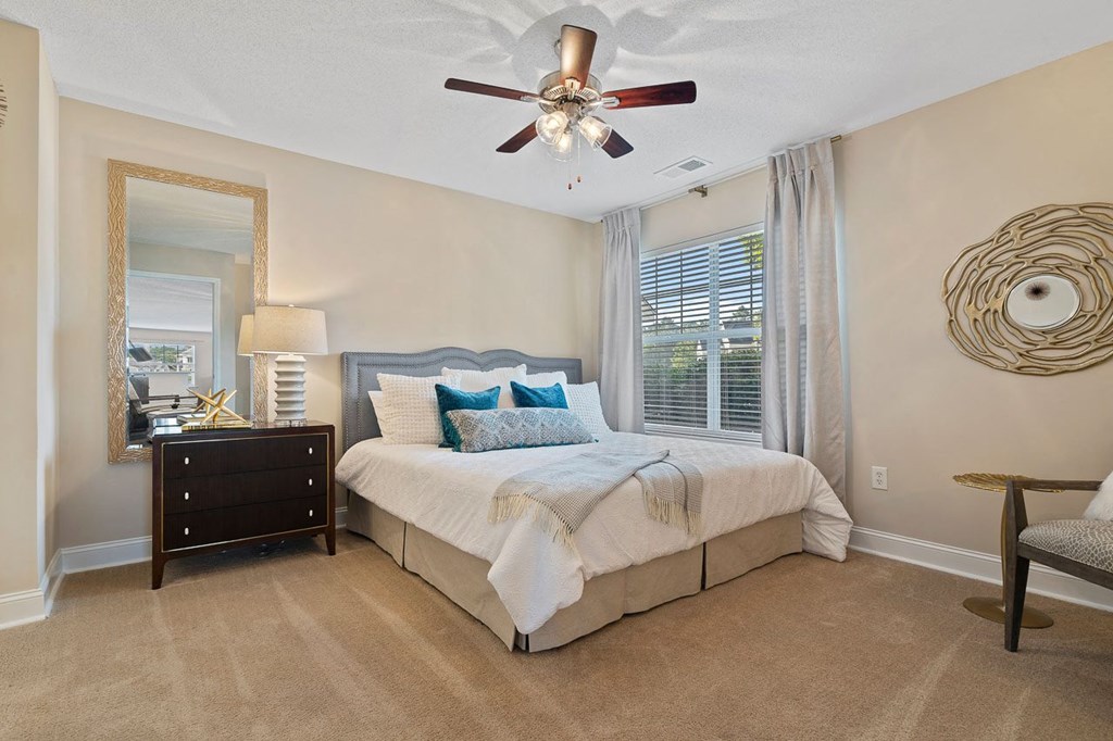 a bedroom with a bed and a ceiling fan