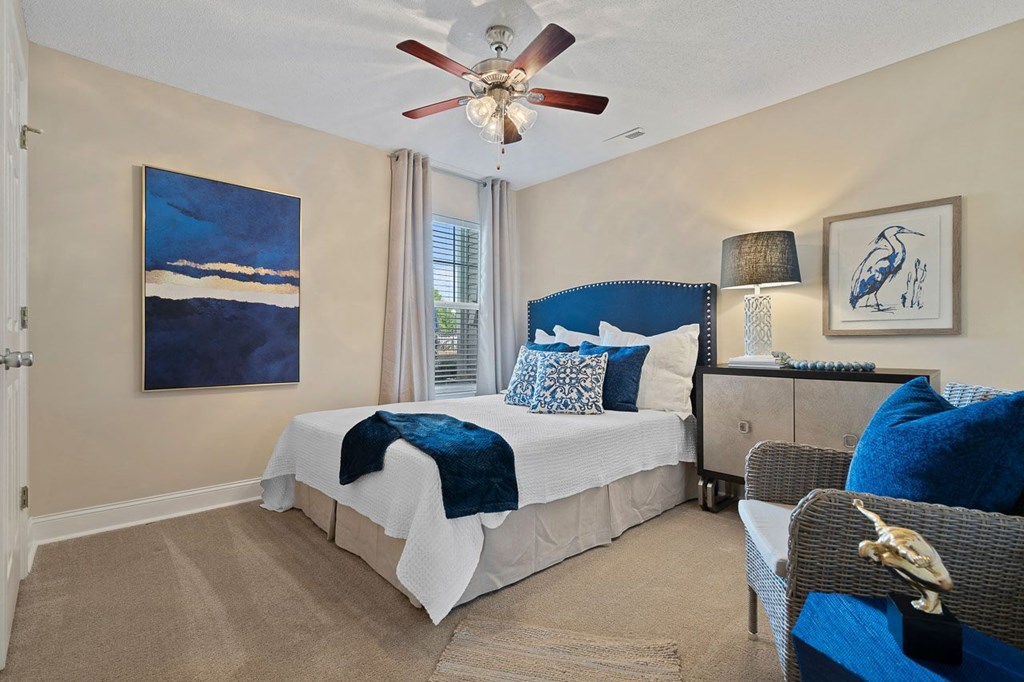 a bedroom with a bed and a ceiling fan