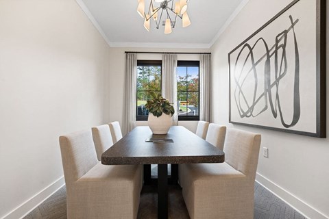 a dining room with a table and chairs