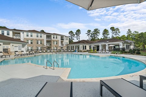 a large swimming pool with buildings in the background
