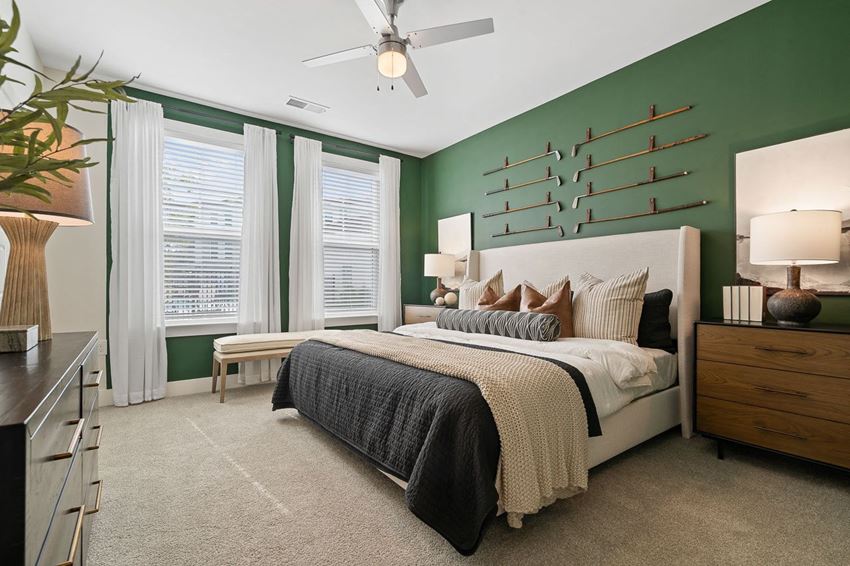 a bedroom with green walls and a white bed