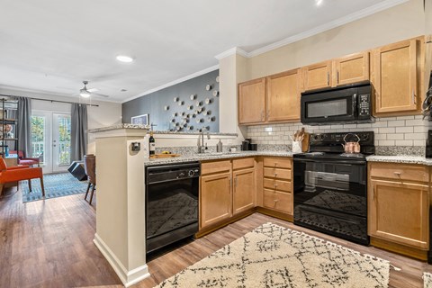 a kitchen with black appliances and wooden cabinets