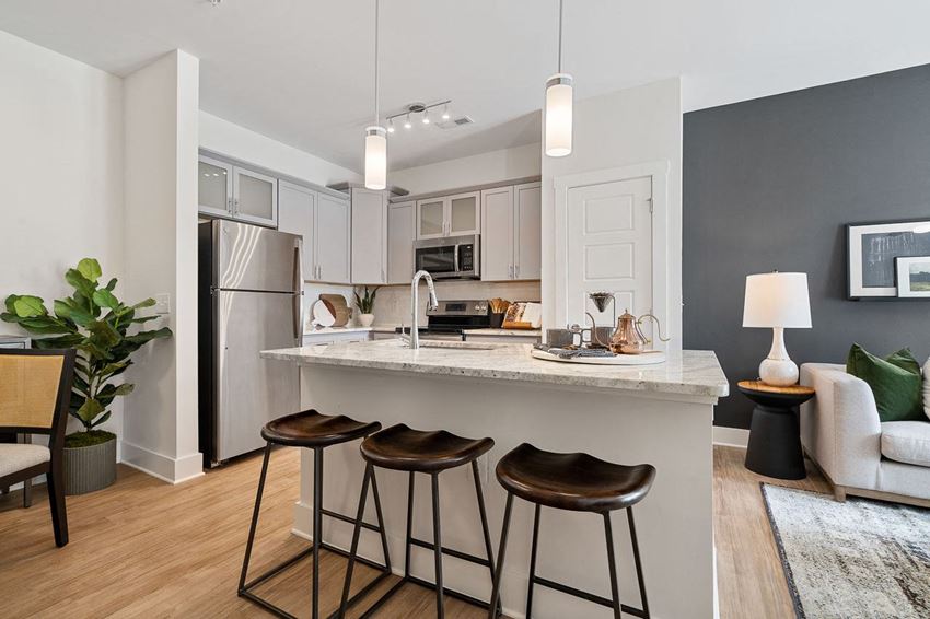 a kitchen with a counter top and three stools