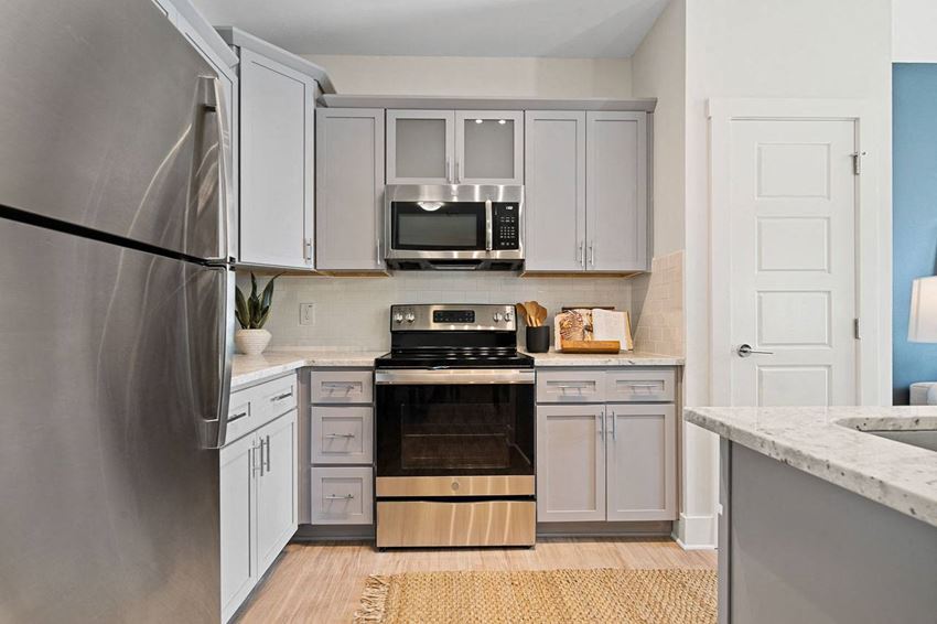 a kitchen with stainless steel appliances and white cabinets
