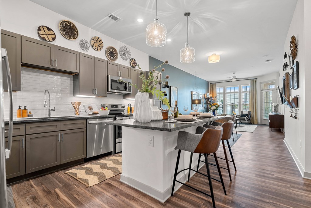 an open kitchen with a large island and a dining table