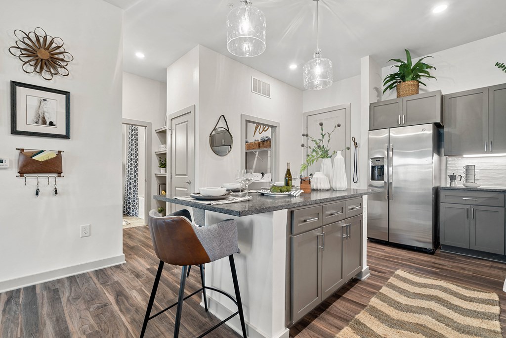 an open kitchen with stainless steel appliances and a counter top