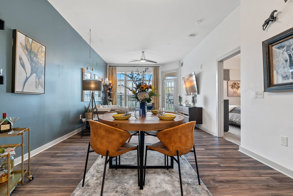 a dining room with a wooden table and chairs