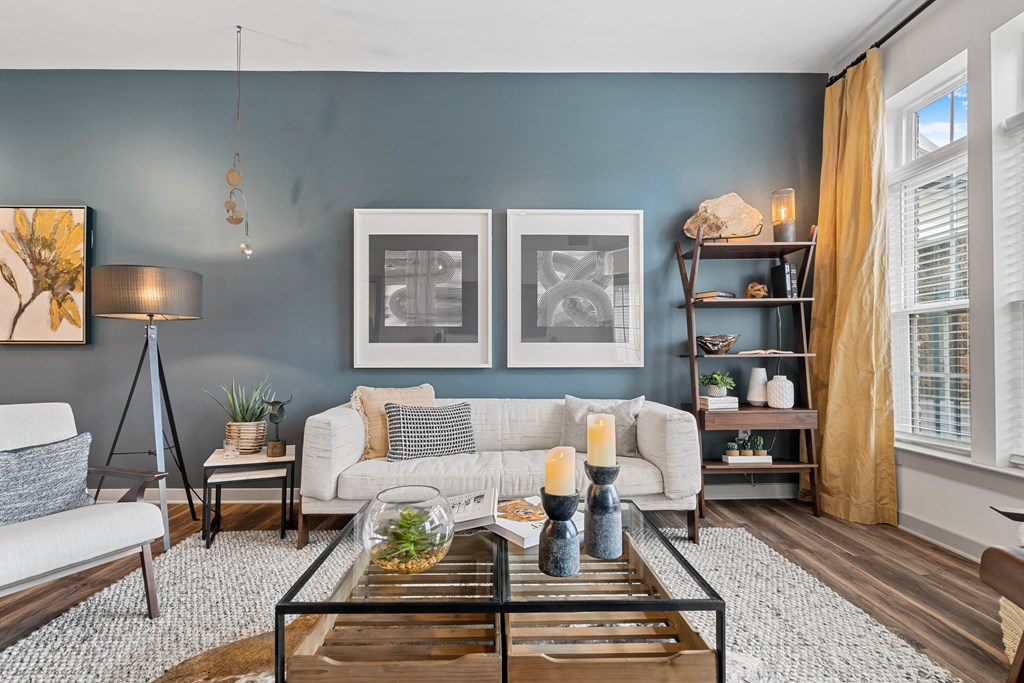 a living room with blue walls and a white couch