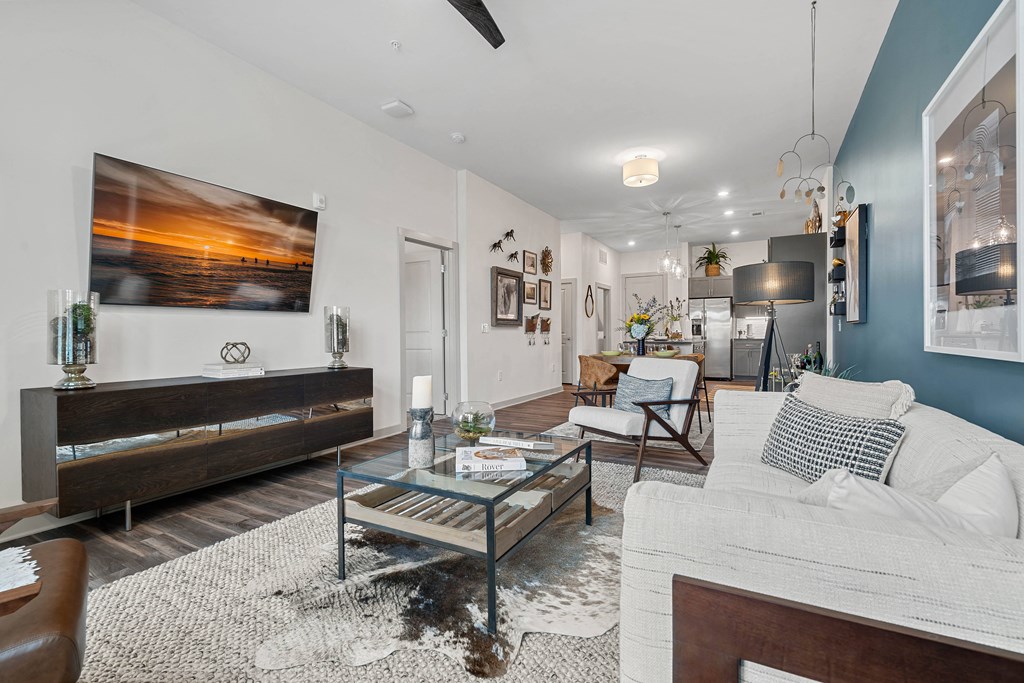 a living room with a couch and a glass coffee table