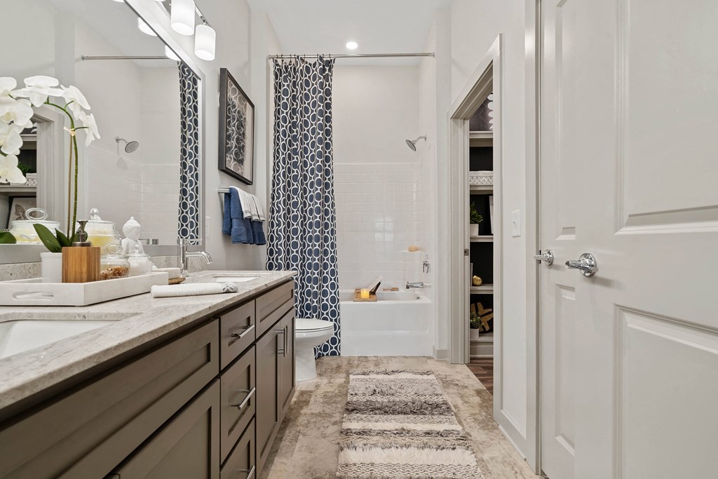 a bathroom with a shower and a sink and a mirror