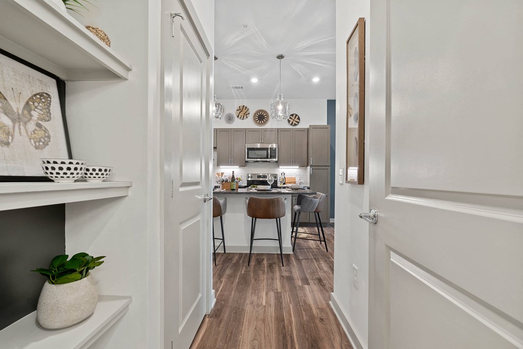 a view of a kitchen and a dining room from a doorway