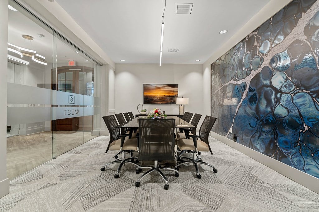 a conference room with a table and chairs