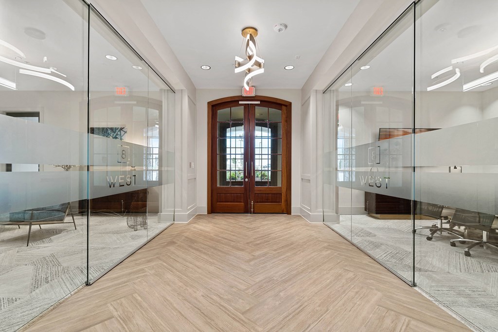 a reception room with glass doors and a wood floor
