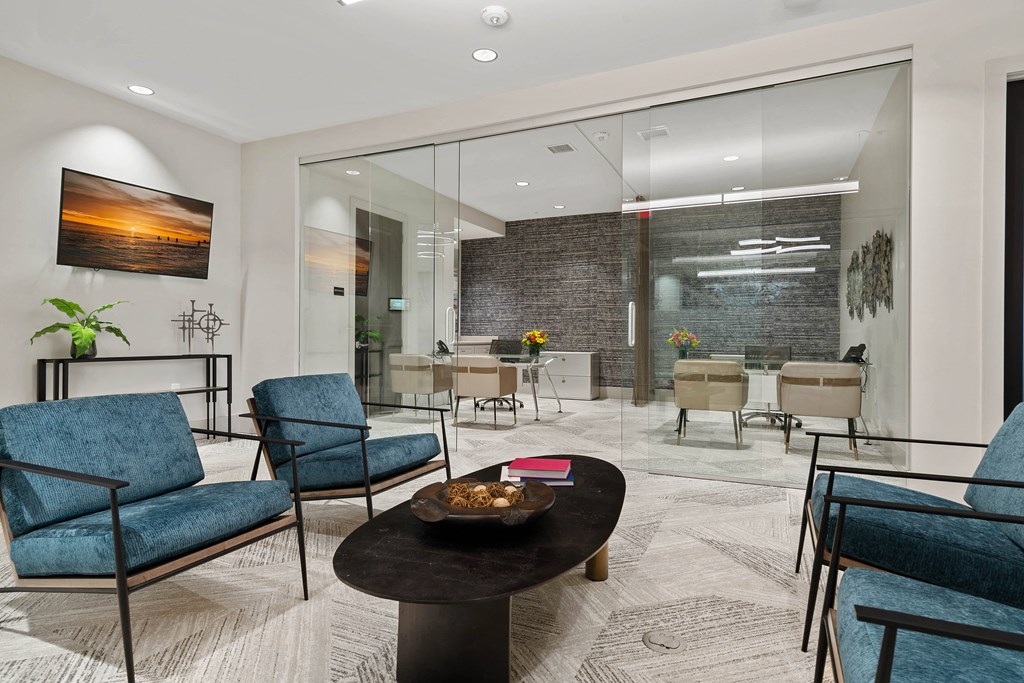a lobby with blue chairs and a table