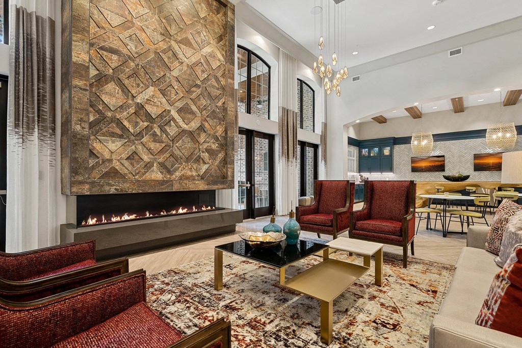 a living room with couches and chairs and a fireplace