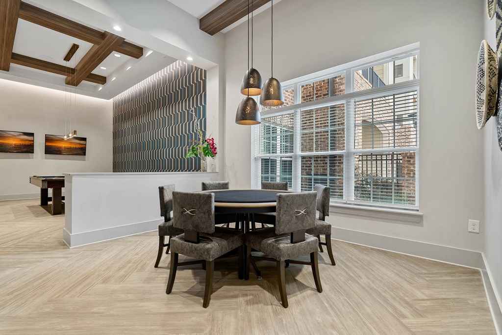 a dining room with a table and chairs and a large window