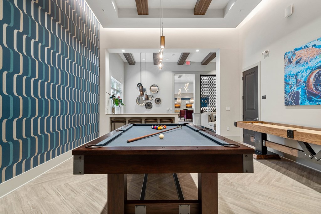 a pool table in a game room with a blue wall