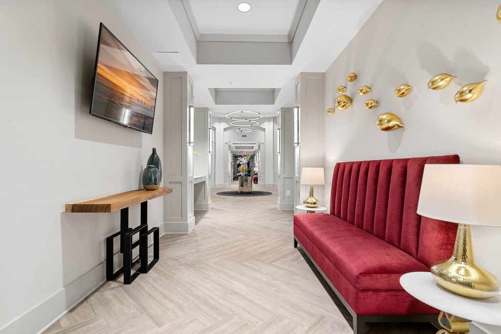 a long hallway with a red couch and a television
