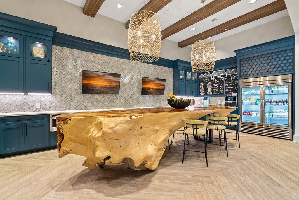 a dining room with a large table and chairs and a bar with a gold counter