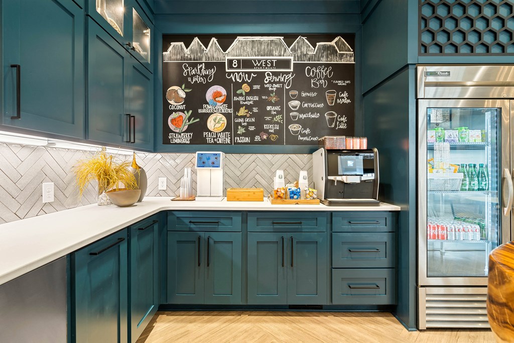 a kitchen with blue cabinets and a counter and a refrigerator