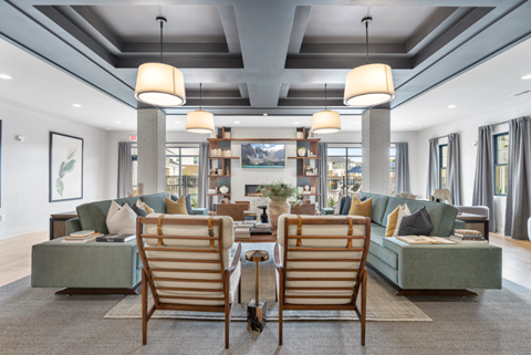 a living room with chairs and couches
