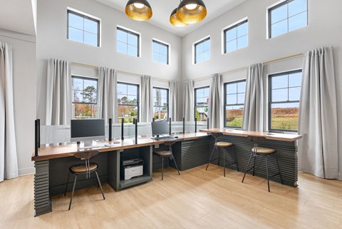 a large office space with desks and chairs and windows