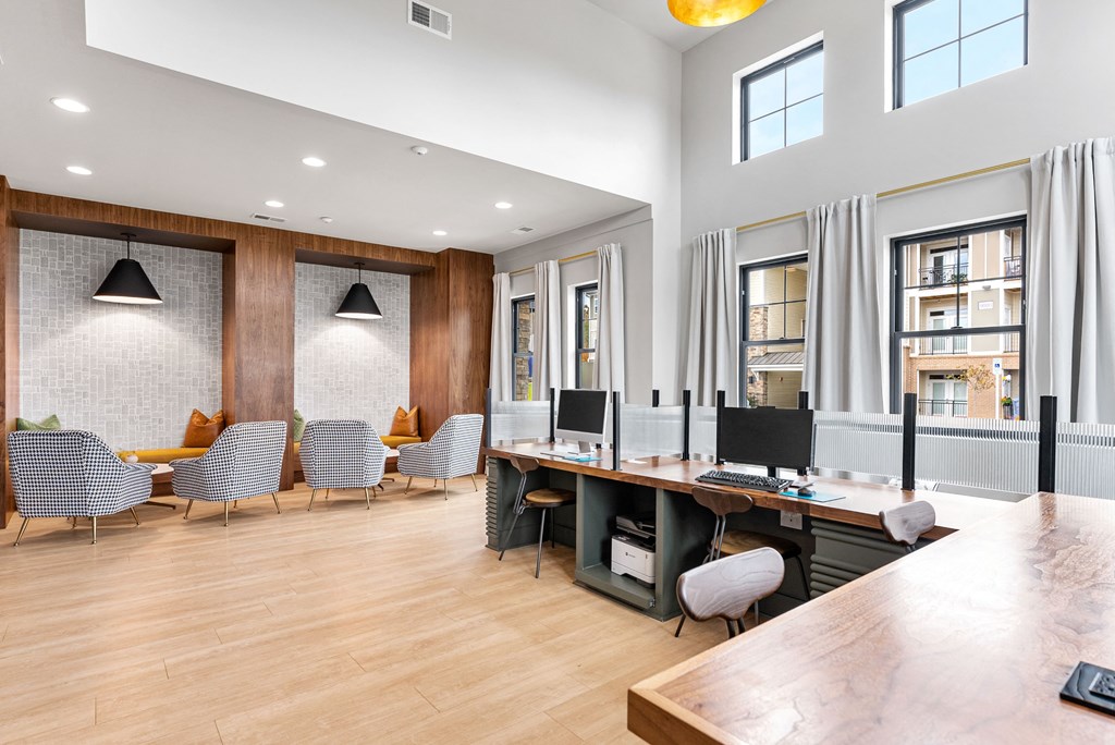 a conference room with a desk and chairs and a large window