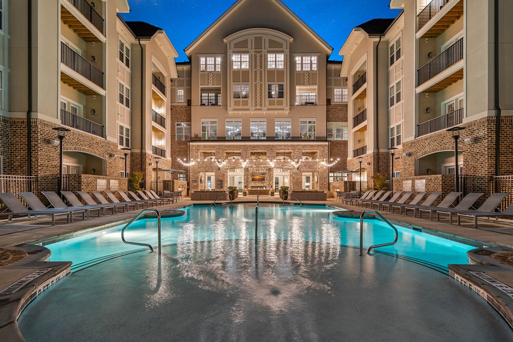 a large swimming pool in front of an apartment building