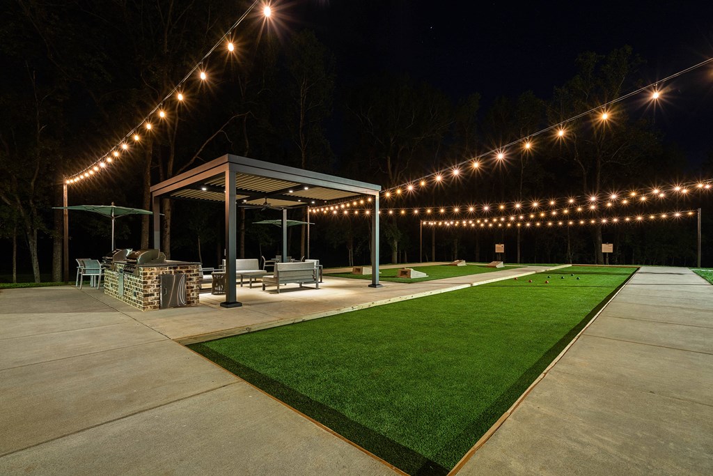 the pavilion at night with lights on it
